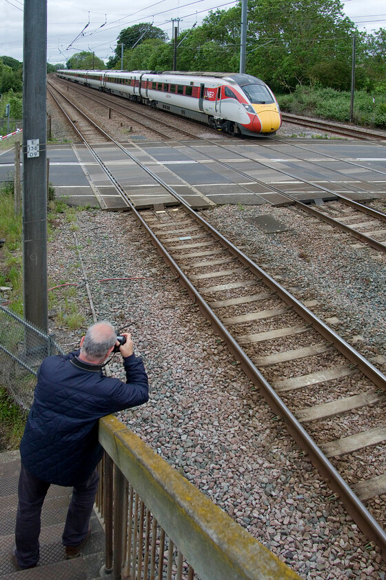 Andy & 801026, GR 09.30 London King's Cross-Edinburgh Waverley (1S10, 5L), Tallington 
 Andy captures his image of the 09.30 King's Cross to Edinburgh LNER Azuma service at Tallington worked by 801026. This four-track section of the ECML is busy with the barriers staying down for prolonged periods causing lengthy delays to road users much to the chagrin of the locals. Diversions via other routes don't help much as these also cross the line via level crossings! 
 Keywords: Andy 801026 09.30 London King's Cross-Edinburgh Waverley 1S10 Tallington LNER Azuma