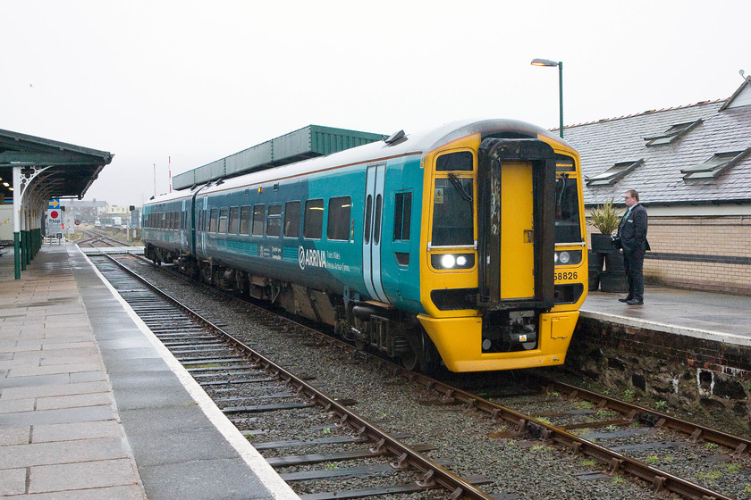 158826, AW 12.09 Birmingham International-Pwllheli (2K15), Barmouth station 
 158826 pauses at Barmouth station forming the 12.09 Birmingham International to Pwllheli service. It had a fairly generous dwell time at the station enabling the train crew to have a chat with each other. 
 Keywords: 158826 12.09 Birmingham International-Pwllheli 2K15 Barmouth station