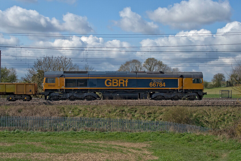 66784, 09.42 Kings Langley-Bescot (6G51, 13E), between Roade & Ashton 
 About fifteen minutes behind the previous infrastructure train, see..... https://www.ontheupfast.com/p/21936chg/30013731729/x66735-09-13-king-s-langley-bescot the 09.42 Kings Langley to Bescot 6G51 passes between Roade and Ashton. Leading a variety of wagons including some JNA and MRA side tipping wagons 66784 'Keighley & Worth Valley Railway 50th Anniversary 1968-2018' is seen. The train had worked on the down slow from Kings Langley as far as Ledburn Junction where it had been put on to the fast line to run as far as Hanslope Junction where it reverted back to the slow again. 
 Keywords: 66784 09.42 Kings Langley-Bescot 6G51 between Roade & Ashton Keighley & Worth Valley Railway 50th Anniversary 1968-2018