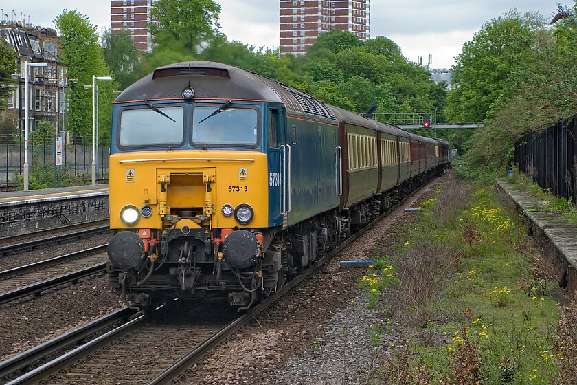 57313, outward leg The Channel Coast Express, 06.53 Doncaster-Brighton (1Z64, 9L), Kensington Olympia station 
 Former Virgin Thunderbird 57313 (previously named 'Tracy Island') hauls the outward leg of The Channel Coast Express charter. Operated by West Coast the train left Doncaster at 06.53 ending up at Brighton giving passengers nearly five hours to enjoy the south coast resort before heading for home but with 57316 leading. 
 Keywords: 57313 The Channel Coast Express 06.53 Doncaster-Brighton 1Z64 Kensington Olympia station