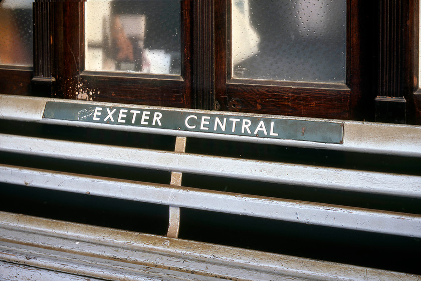 SR enamel on bench, Exeter Central station 
 An ex British Railways (Southern Region) enamel running-in sign on a bench at Exeter Central station. The general grime generated by a railway environment is seen on the bench as it basks in the summertime evening sunshine. It is general filth like this that people hark back to when the nationalisation debate is under discussion. 
 Keywords: SR enamel on bench Exeter Central station