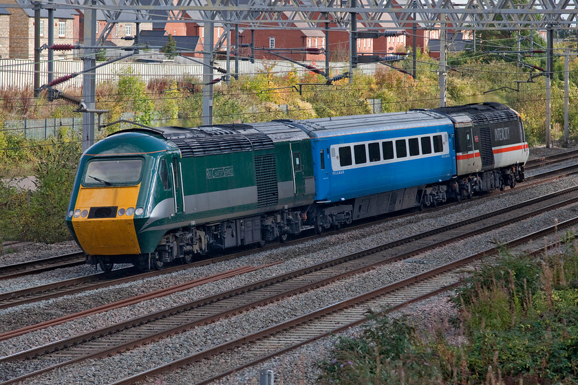 43058 & 43049, 10.23 Eastleigh Arlington-Crewe HS (5Z58, 4E), site of Roade station 
 An HST returns to the WCML again! However, it's not quite as they used to be when in operation by Virgin Trains! Now rather than being in public service they are utilised by the charter market and very well they are going down too! With 43058 leading and 43049 trailing a recently refurbished and repainted Mk. III coach is sandwiched between the two. The coach is returning from Arlington's at Eastleigh with the train operating as 5Z58 10.23 Eastleigh to Crewe's LSL base. Both these power cars are former EMT ones that both came out of service in May 2021 but now are seen passing the site of Roade station but now on the West Coast route rather than the Midland. 
 Keywords: 43058 43049 10.23 Eastleigh Arlington-Crewe HS 5Z58 site of Roade station HST