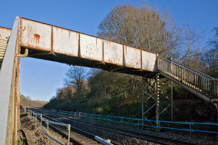 Middlehill Footbridge, 102 miles, 46 chains from London Paddington, just prior to demolition (For GWML electrification) ST805680 
 A footbridge that has stood for many years spanning the GWML between Bath and Chippenham basks in the winter sunshine a week or so prior to its demolition and replacement by a modern green and massively over-engineered structure. The reason for this architectural vandalism is so the electrification of the line from London to Bristol can be constructed unhindered. I suppose that if technology dictates then things have to change but it does seem a shame that such a characteristic structure has to succumb as a result.

NB The demolition was a complete waste of time and resources as was much other work as the electrification west of Thingley Junction (Chippenham) was to be cancelled by government dictate in November 2016 
 Keywords: Middlehill Footbridge 102 miles 46 chains from London Paddington GWML electrification ST805680