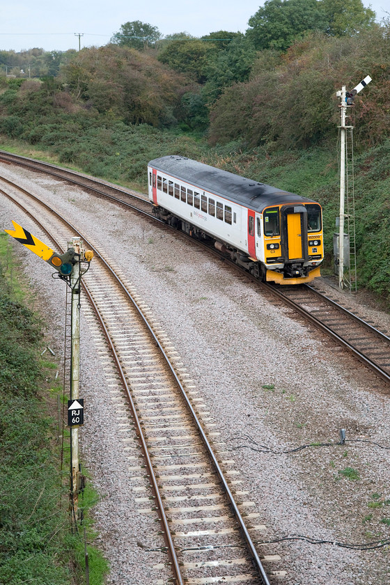 153309, LE 12.58 Norwich-Lowestoft (2J76), Holly Farm bridge, Reedham 
 With the previously open swing-bridge, behind where I am standing, now closed to river users, 153309 has the road and is seen with the 12.58 Norwich to Lowestoft. It is about to pass under Reedham's Holly Farm bridge and roll out over the bridge to continue its journey across the Fens. Notice that Reedham Junction's distant signal is also pulled off for a Norwich bound service. 
 Keywords: 153309 12.58 Norwich-Lowestoft 2J76 Holly Farm bridge, Reedham