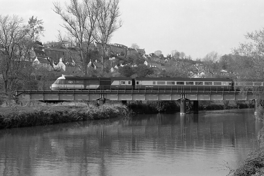 Class 43, unidentified working, River Avon crossing, Bradford-on-Avon 
 Another photograph taken from Bradford-on-Avon's Barton Farm crossing of the railway bridge that crosses the Avon with the town climbing the hill in the background. This view shows a diverted Class 43 HST but I am unable to even identify its direction of travel let alone its working such is my poor note-taking on this particular day! With the characteristic oil stain down the side of the power car this is the look that we all remember from the early days of HST operations and one that they are always associated with. 
 Keywords: Class 43 River Avon crossing Bradford-on-Avon HST