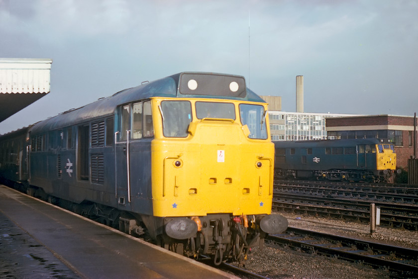 31258, 09.15 Weymouth-Bristol Temple Meads & 31254, going on-shed, Bristol Temple Meads station 
 Standing on the platform end at Bristol Temple Meads, opposite Bath Road depot, reveals two class 31s. To the left is 31258, an Old Oak Common locomotive, that has just arrived with the 09.15 from Weymouth. Notice that it has the cowling that covers the radiators removed, an accident or a deliberate act by the OOC team to improve cooling? Over by Temple Meads Yard signal box is 31254, this was one of Bath Road's finest and one that only had exactly a year left in service from when this picture was taken. 
 Keywords: 31258 09.15 Weymouth-Bristol Temple Meads 31254 on-shed Bristol Temple Meads station