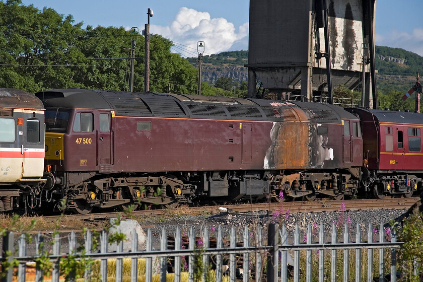 47500, awaiting its fate, Carnforth WCR 
 A sad sight in WCR's yard at Carnforth sees former GWR 150 celebrity locomotive 47500 (previously named 'Great Western') awaiting its fate. In January last year (2012), it caught fire after derailing at Ordsall in Manchester whilst being towed at the rear of an empty stock working. Given the damage seen here, I suspect that the locomotive will be cannibalised for spares and then cut up on site. 
 Keywords: 47500, awaiting its fate, Carnforth WCR West Coast Railways