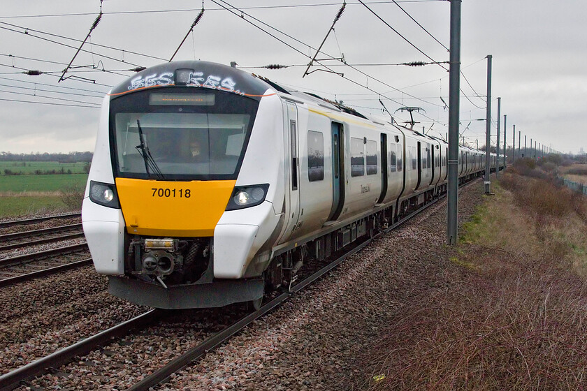 700118, TL 07.24 Peterborough-London King's Cross (1P13, 1E), Sandy TL176510 
 Managers at Thameslink were able to operate some sort of service despite the industrial action in place on this Saturday. The 07.24 Peterborough to Kings Cross service approaches its next stop at Sandy taken from New Zealand bridge. Like many other Desiro City units this example has been subject to a vandal attack above the drivers window. I am not sure as to why they seem prone to graffiti being applied in this spot on their bodies 
 Keywords: 700118 07.24 Peterborough-London King's Cross 1P13 Sandy TL176510 Thameslink