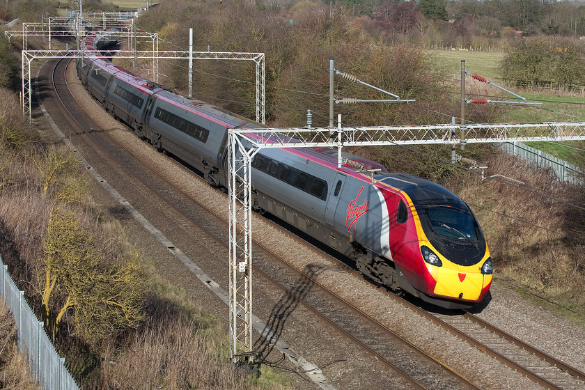 390157, VT 10.35 Manchester Piccadilly-London Euston (1A24, 1L), A45 Weedon bypass bridge 
 390157 'Chad Varah' forming the 10.35 Manchester Piccadilly to London Euston is seen from the newly opened A45 bypass road bridge just north of the village of Weedon. This spot, and the one looking south from this location, are extremely welcome as there is very few photographic locations on this stretch of line, a situation made even worse since the installation of the dreaded palisade fencing. 
 Keywords: 390157 10.35 Manchester Piccadilly-London Euston 1A24 A45 Weedon bypass bridge