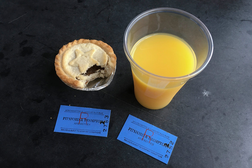 Tickets, mince pie & juice, Pitsford return 
 Our tickets along with a mince pie and a glass of juice aboard the 12.00 Pitsford and Brampton return. We were hauled by 31289 'Phoenix' in a Mk.1 open coach enjoying cloudy and dull views of the Northamptonshire countryside. 
 Keywords: Tickets mince pie & juice Pitsford return