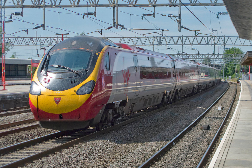 390016, VT 13.55 Manchester Piccadilly-London Euston (1A41), Stafford station 
 Virgin Trains always seem to make an extra effort to keep their stock looking smart. The condition of 390016 is no exception to this still wearing its smart livery over ten years after it entered service on the WCML. The Pendolino is seen passing through Stafford's centre up road with the 13.55 Manchester Picadilly to Euston service that has taken the Crewe route rather than the more direct but slower Stoke route. Once the train reaches Colwich Junction it will tear down the Trent Valley route at full speed to reach London in an hour and a half. 
 Keywords: 390016 13.55 Manchester Piccadilly-London Euston 1A41 Stafford station Virgin Pendolino