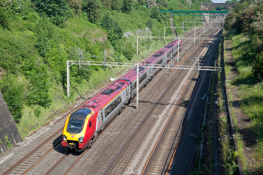 Class 221, VT 06.55 Holyhead-London Euston (1A13), Roade Cutting 
 A class 221 races noisily through Roade Cutting working the 06.55 Holyhead to London Euston. Notice the recently refurbished aqueduct in the background that carries a small stream across the line. 
 Keywords: Class 221 06.55 Holyhead-London Euston 1A13 Roade Cutting