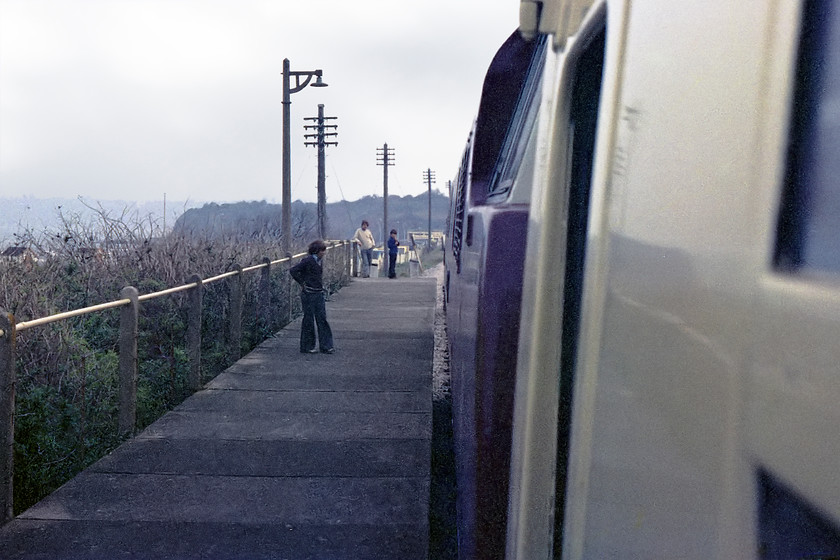 D1062, 16.00 Paignton-Kingswear, Goodrington Sands station 
 Taken from the leading coach behind D1062 'Western Courier' as it leaves Goodrington sands station with the 16.00 Paignton to Kingswear. I seem to remember that the driver really opened up D1062 as it left preparing for the sharp climb up to Churston station. It could only be the 70s; look at the flares and collar! 
 Keywords: D1062 16.00 Paignton-Kingswear Goodrington Sands station