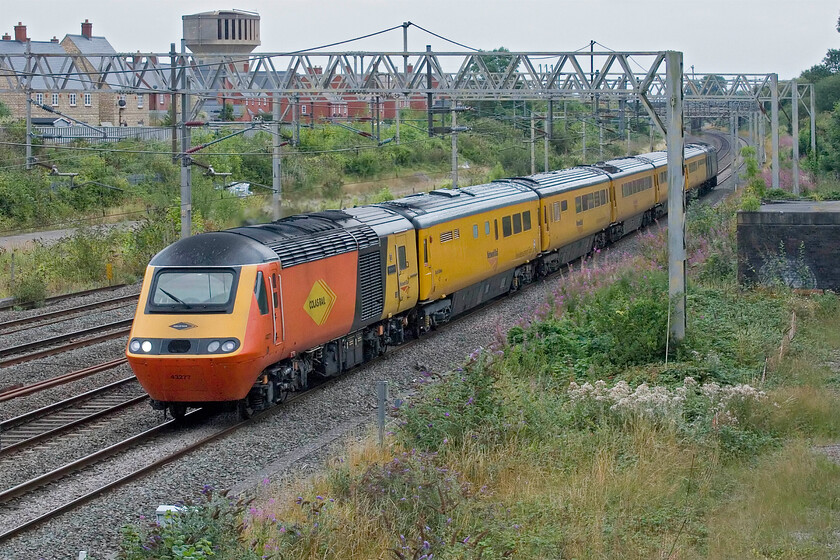 43277 & 43357, 11.59 Crewe Up & Down Pottery Loop-Derby R.T.C via London Euston (1Q29, RT), site of Roade station 
 With Colas branded 43277 'Safety Task Force ' now leading the 11.59 Crewe to Derby RTC via London Euston returns past Roade. It is now on the down fast line and so will continue on the 'old line' via Weedon rather than taking the Northampton loop. At the rear 43357 is giving the NMT a shove after leading the up working as far as Euston earlier. 43277 was last seen and photographed back in 2021 soon after it had been taken out of service with EMR, see.... https://www.ontheupfast.com/p/21936chg/30019707109/x43277-arley-station-hst 
 Keywords: 43277 43357 11.59 Crewe Up & Down Pottery Loop-Derby R.T.C via London Euston 1Q29 site of Roade station Colas HST NMT Safety Task Force