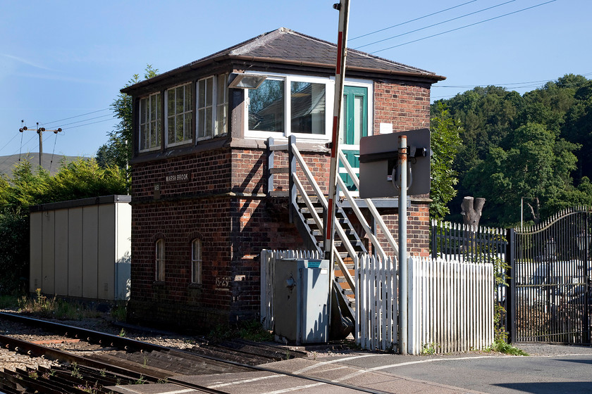 Marsh Brook signal box (LNW & GW Joint, 1872) 
 Another lovely design of box still wearings its wooden nameboard is Marsh Brook just south of Church Stretton. It also dates from 1872, like Dorrington, and appears to be an identical LNR/GW joint Type 1 design. It is probably the best of the remaining few boxes of this type and design and is also one of the oldest still in use today. When I visited in 1981, I noted that the gates were mechanically operated. In 1986 I also visited and was permitted access to the box. It is also worth noting that whilst the box is referred to as Marsh Brook, the village in which it is situated is Marshbrook. 
 Keywords: Marsh Brook signal box