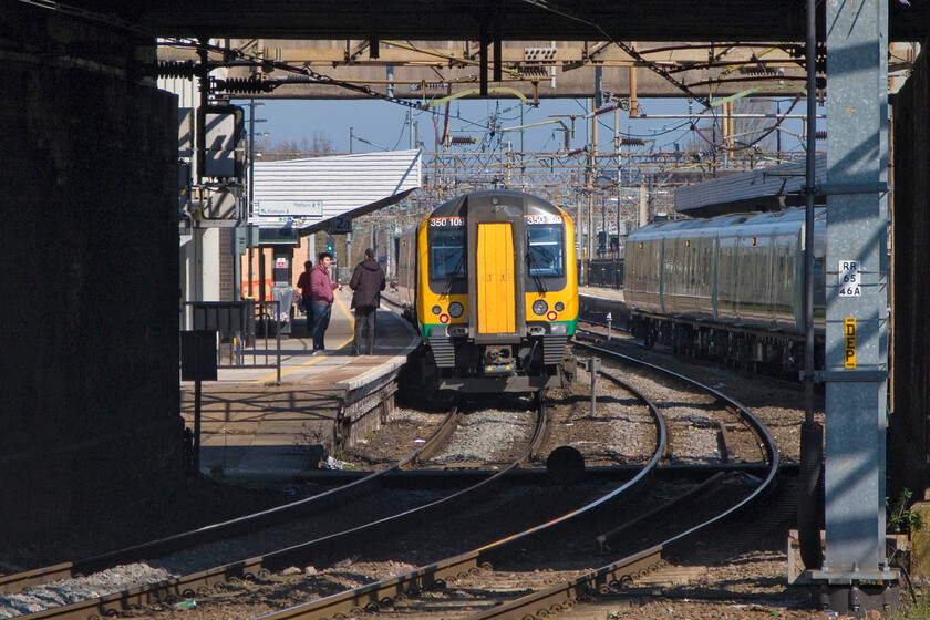 350109, LM 09.49 London Euston-Birmingham New Street, Northampton station 
 Framed by Northampton's Westbridge (A428) bridge 350109 is seen working the 09.49 Euston to Birmingham New Street service. I am standing in the rear station car park that affords reasonable views of the lines to the south of the station. However, according to the plans for the station redevelopment, this area is going to be closed off to the public and us photographers alike to become secure parking for railway staff. Therefore, views such of this will soon become a thing of the past. 
 Keywords: 350109 09.49 London Euston-Birmingham New Street Northampton station London Midland Desiro