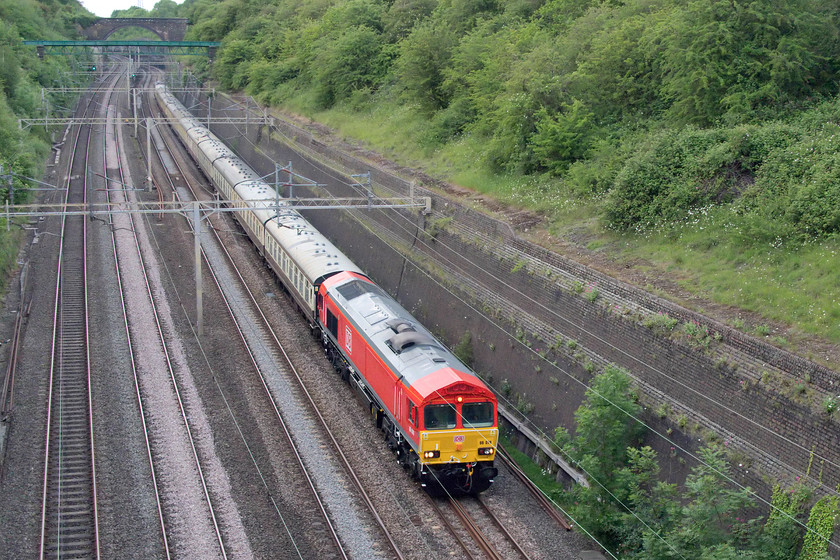 66078 & 66038, return leg of The Curvey Weaver, 13.55 Garston Freightliner terminal-London Euston (1Z79), Roade Cutting 
 In the evening, the returning Curvey Weaver railtour makes its way through Roade cutting led by 66078 looking very smart in its recently applied DB cherry red livery that was completed only a week earlier. It is sobering to think that this 66 has been operating on the UK network for over twenty years now. 66038 brings up the rear of the 13.55 Garston Freightliner terminal to London Euston that I believe was running as 1Z79; can anybody confirm this? 
 Keywords: 66078 66038 The Curvey Weaver 13.55 Garston Freightliner terminal-London Euston 1Z79 Roade Cutting