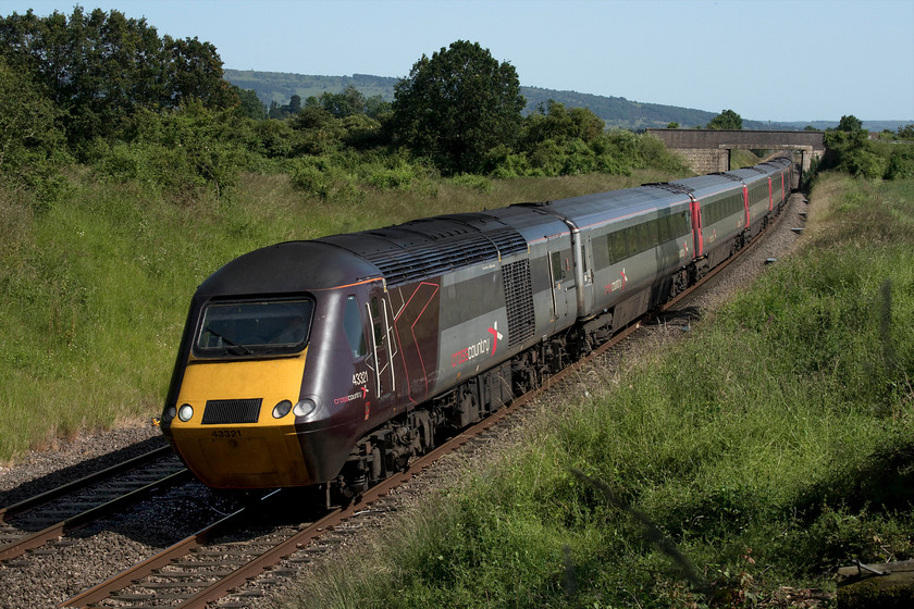 43321, XC 13.25 Plymouth-Edinburgh Waverley (1S53, 11L), Croome Perry Wood SO900459 
 If you had said to me some thirty-five years ago, when I was living in and photographing trains in this area, that I would be excited when an HST passed I would have laughed! With respect to them, I did take some images at the time but then they were in the classic 'flying banana' livery rather than this smart Crosscountry paint job. 43321 leads the 13.25 Plymouth to Edinburgh Waverley 1S53 service past Croome Perry Wood on a stunning summer afternoon. The 981 feet high Bredon Hill can be seen in the background. Amongst other things, it featured in A. E. Housman's 1896 anthology, A Shropshire Lad. 
 Keywords: 43321 13.25 Plymouth-Edinburgh Waverley 1S53 Croome Perry Wood SO900459