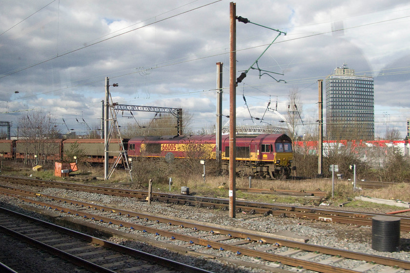 66005, 08.58 Halewood-Southampton Eastern Docks (6O38), Wembley Yard 
 66005 passes through Wembley yard at the head of the 08.58 Halewood to Southampton Eastern docks car-liner train. It will be carrying many new JLR models for export that have been built at their huge Halewood factory on Merseyside. 
 Keywords: 66005 08.58 Halewood-Southampton Eastern Docks 6O38 Wembley Yard