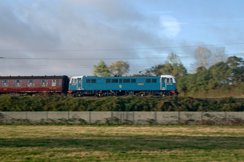 86259, outward leg of The Cumbrian Mountain Express, 07.10 London Euston-Carlisle (1Z86), Milton crossing 
 Rather than opt for the normal three-quarter view of 86259 'Les Ross/Peter Pan' I opted for a pan shot that caught the early morning sun more effectively. It is seen leading the outward leg of the usual Cumbrian Mountain Express 1Z86 working from Euston to Carnforth for steam haulage from there to Carlisle. The train is seen just north of Roade cutting on the Weedon loop line at Milton crossing. 
 Keywords: 86259 The Cumbrian Mountain Express 07.10 London Euston-Carlisle 1Z86 Milton crossing.jpg