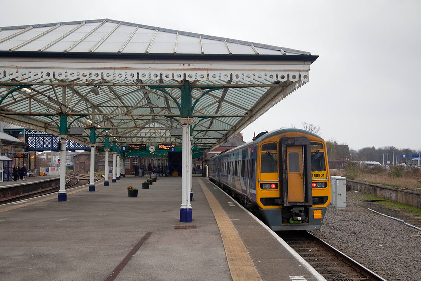 158901, NT 16.04 Bridlington-Hull (1G19, 3E), Bridlington station 
 On the windswept and desolate platform at Bridlington, yes. it's mid-April, 158901 sits idle waiting to work the 16.04 local stopper service to Hull. Bridlington station is a superb structure complete with restored canopies and lovely wrought ironwork. It has a lively atmosphere and reminds you of times past when many thousands of holidaymakers arrived by train at the station for their week in the sun! 
 Keywords: 158901 16.04 Bridlington-Hull 1G19 Bridlington station