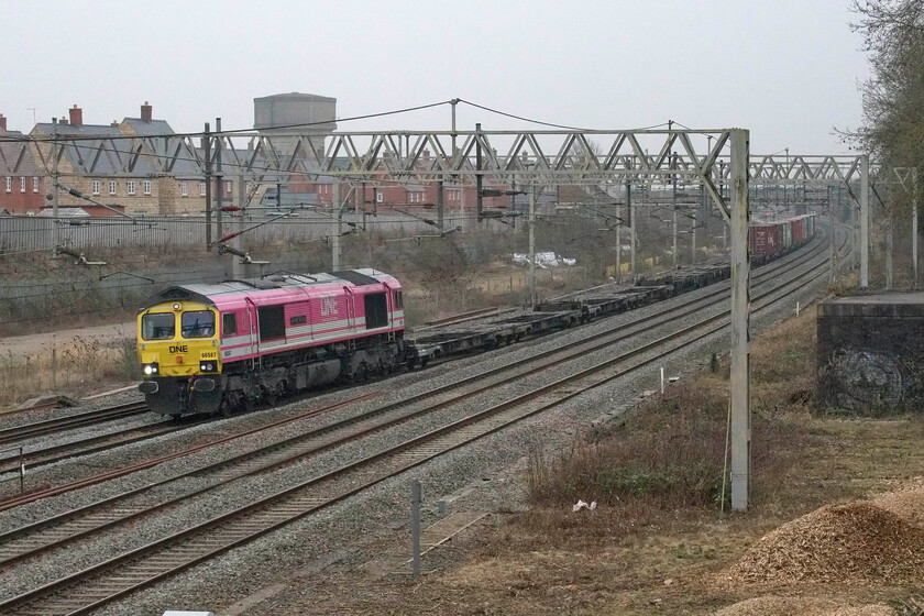 66587, 09.12 Felxstowe North-Trafford Park (4M63, 1L), site of Roade station 
 One of the 'Pink Ones' 66587 'As one We Can' brings a splash of brightness to the dull Northamptonshire weather as it passes through Roade on the down slow line. The Freightliner operated Class 66 in partnership with the relatively new global container shipping company OceanNetworkExpress (ONE) was leading the 4M63 09.12 Felixstowe to Trafford Park service. Rather like the earlier 4M07 this was also very lightly loaded perhaps indicating more difficulties with international shipping and contributing to further consumer shortages and thus driving our old enemy inflation currently running at a thirty-year high of 5.1%. 
 Keywords: 66587 09.12 Felixstowe North-Trafford Park 4M63 site of Roade station As one We Can