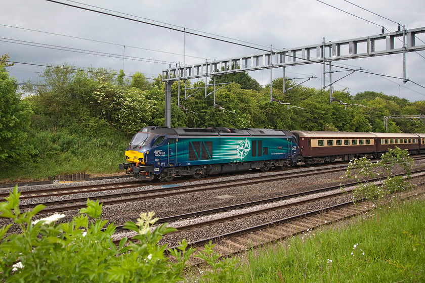 68017, 10.25 Old Oak Common-Kidderminster SVR ECS (0Z72), Ashton Road Bridge 
 68017 'Hornet' brings up the rear of the 10.25 Old Oak Common to Kidderminster SVR ECS stock working. It is seen passing between Road and Ashton in Northamptonshire. With it being such a dull day the bright DRS liveried class 68 certainly stands out! 
 Keywords: 68017 10.25 Old Oak Common-Kidderminster SVR ECS 0Z72 Ashton Road Bridge