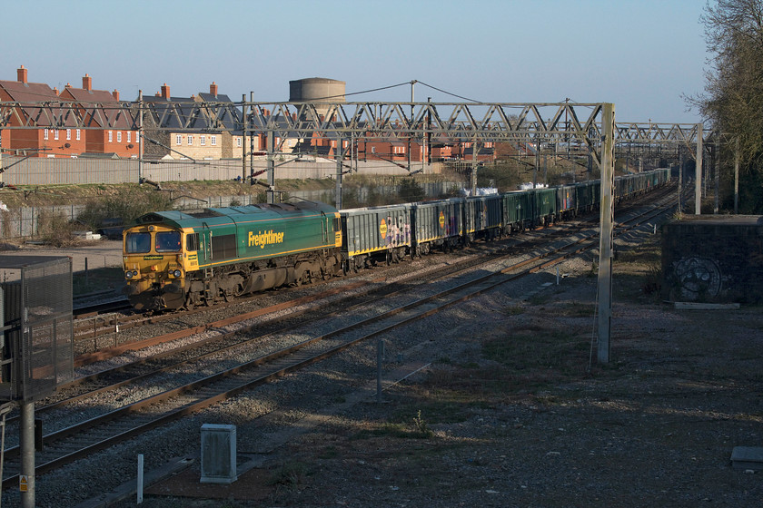 66610, 14.15 Stewarts Lane-Guide Bridge (17E) site of Roade station 
 66610 leads a Friday only freight working passing the site of Roade station in the superb late afternoon sunshine. The 14.15 Stewarts Lane to Guide Bridge is composed of a mixture of MWA-B and MJA wagons none of which appeared to be loaded. The Polish built MWA-B wagons arrived in the United Kingdom during 2018 and 2019 but some have already been ruined by the worst efforts of the graffiti vandals. 
 Keywords: 66610 14.15 Stewarts Lane-Guide Bridge site of Roade station Freightliner