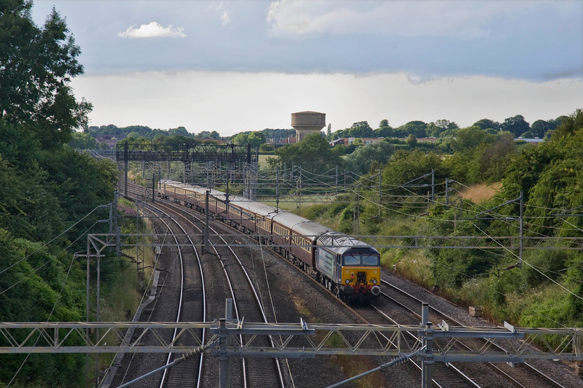 57304, return leg of British GP special, Milton Keynes-Soho-Milton Keynes-London Euston (1Z65), Victoria bridge 
 With 57304 'Pride of Cheshire' on the rear of Northern Belle's British Grand Prix charter the train passes Victoria bridge with the village of Roade in the background. The charter has just left Milton Keynes taking motor racing fans back from the Grand Prix travelling first to Birmingham and then south again to Euston. 
 Keywords: 57304 British GP special Milton Keynes-Soho-Milton Keynes-London Euston 1Z65 Victoria bridge Pride of Cheshire DRS Northern Belle