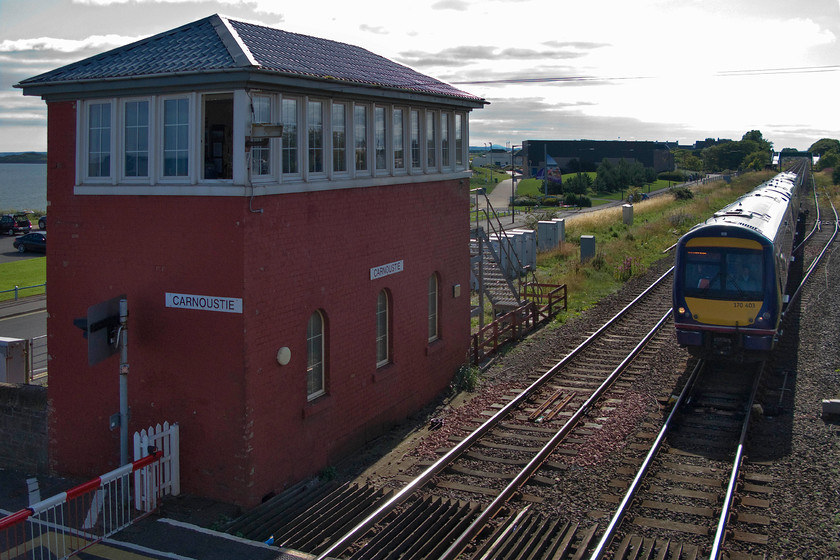 170403, SR 15.28 Edinburgh Waverley-Inverurie (1A78), Carnoustie station 
 Taken right into the afternoon sun but I like to break the rules at times! 170403 slows for its stop at Carnoustie station forming the 15.28 Edinburgh to Inverurie ScotRail service. It is passing the location of the first station at Carnoustie that closed in 1900 to move to its present location behind where I am standing. The fine 1898 Caledonian Railway signal box still stands that controls the level crossing and colour lights in the area. 
 Keywords: 170403 15.28 Edinburgh Waverley-Inverurie 1A78 Carnoustie station ScotRail