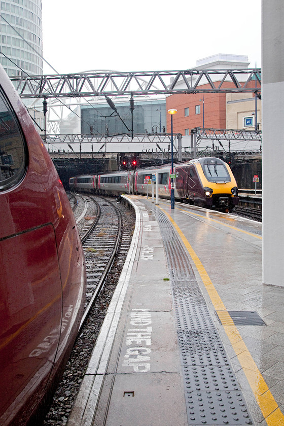 220016, XC 06.02 Guildford-Newcastle (1E79) & 390123, VT 06.43 London Euston-Edinburgh (9S44), Birmingham New Street station 
 My train north to Darlington arrives at Birmingham New Street as the 1E79 06.02 Guildford to Newcastle. To the extreme left is the tail end of 390123 that is about to leave with the 06.43 Euston to Edinburgh service. At the top left hand side of the image is Birmingham's instantly recognisable Rotunda tower. It is now used as student accommodation. I remember it in the 1970s having the famous Double Diamond neon adverts running round the top whilst I was spotting on the platform end. 
 Keywords: 220016 06.02 Guildford-Newcastle 1E79 390123 06.43 London Euston-Edinburgh 9S44 Birmingham New Street station