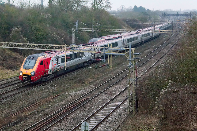 221117, VT 13.40 Birmingham New Street-London Euston (1B24) & class 390, VT 14.03 London Euston-Birmingham New Street (9G25), Victoria bridge 
 An up and a down Birmingham New Street train pass at Victoria bridge near Roade in Northamptonshire. To the right 221117 'The Wrekin Giant' forms the 13.40 ex New Street to Euston, whilst and unidentified class 390 works the 14.03 ex Euston. Both bring a much needed flash of red and silver to a very dull winter's afternoon. 
 Keywords: 221117 13.40 Birmingham New Street-London Euston 1B24 class 390 14.03 London Euston-Birmingham New Street 9G25 Victoria bridge