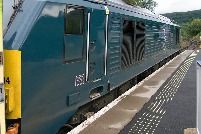 67004, CS 21.16 London Euston-Inverness, Fort-William & Aberdeen sleeper (1S25 & 1Y11), Crianlarich station 
 67004 'Cairn Gorm' stands at Crianlarich station pausing at the head of the down Highland Sleeper from Euston to Fort William. I quite like the livery carried by Caledonian Sleeper locomotives and the Highland stag sitting atop a combined C and S. 
 Keywords: 67004 21.16 London Euston-Inverness, Fort-William & Aberdeen sleeper 1S25 1Y11 Crianlarich station Caledonian sleeper Cain Gorm