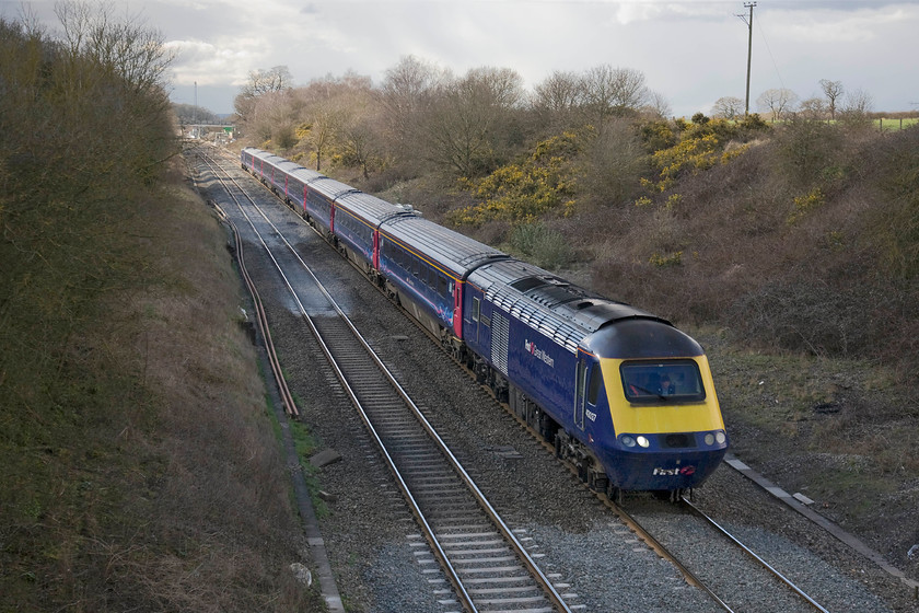 43037, GW 13.30 Bristol Temple Meads-London Paddington (1A19), Baulking 
 With the gorse (Ulex) in full flower on the embankment at Baulking 43037 'Penydarren' leads the 13.30 Bristol Temple Meads to Paddington. The sun had just gone behind an awkward cloud meaning that the front of the train is in shadow with the rear in the light still, better luck with the next shot..... 
 Keywords: 43037 13.30 Bristol Temple Meads-London Paddington 1A19 Baulking