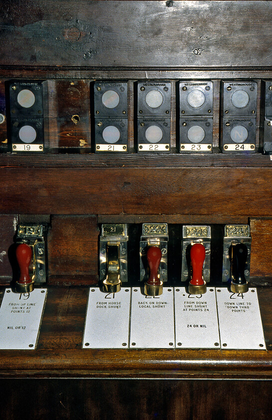 Signal slides & indicators, Salisbury West signal box 
 Slides and indicators inside Salisbury West signal box are seen. With the slide number cast into the top of the frame, the more modern embossed plastic plate is seen containing a little more detail of the particular piece of signalling equipment it operates. The West box was to close just a week after this photograph was taken with control moving to a panel inside a discreet room on Salisbury station's platform two. 
 Keywords: Signal slides indicators Salisbury West signal box L&SWR London and South Western Railway