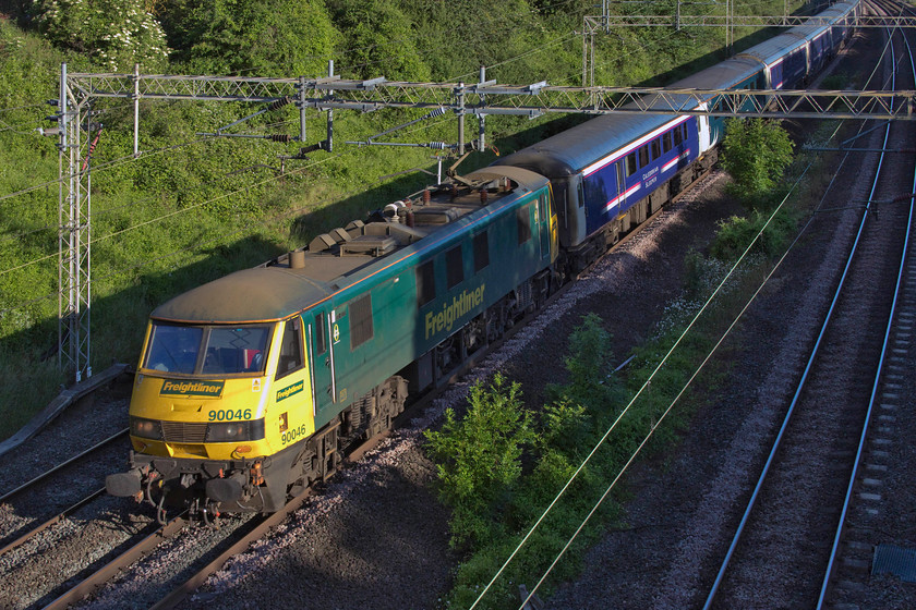 90046, CS 19.50 Fort William, 21.43 Aberdeen, 20.45 Inverness-London Euston (1M16, 5E), Victoria bridge 
 Not the best composed of images but I did have a minor camera malfunction so, I'm going to blame that! I would not normally include it but the Mk.III sleeper stock had only a week left in service so scenes such as this with a class 90 at the helm would soon be confined to the railway history books. 90046 leads the 1M16 highland sleeper past Victoria bridge. As I have said in the introductory text, as it was the longest day I thought that I would photograph both sleepers but the lowland working experienced horrendous delays so I was unable to see it. 
 Keywords: 90046 19.50 Fort William 21.43 Aberdeen 20.45 Inverness-London Euston 1M16 Victoria bridge