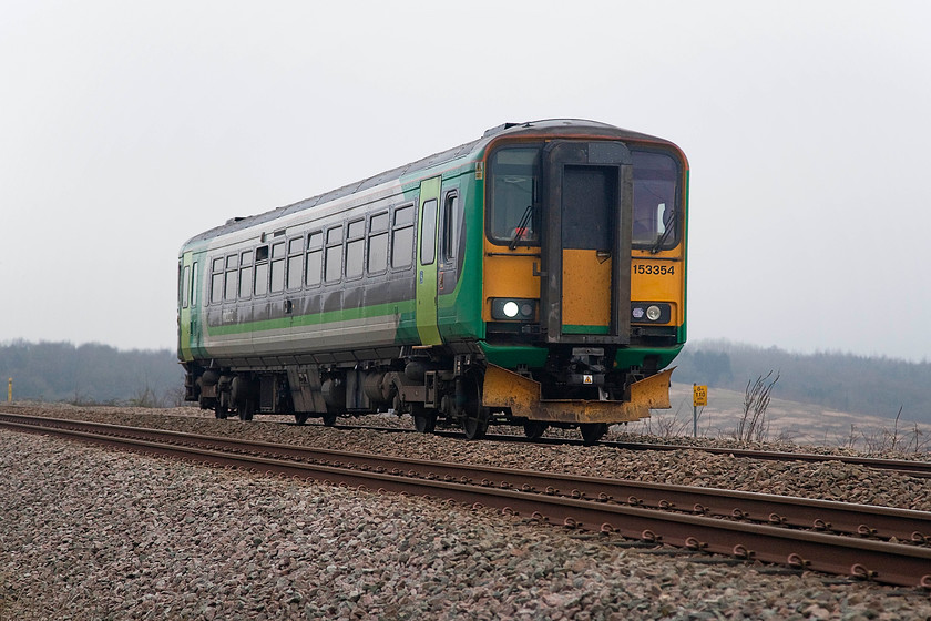 153354, LM 08.39 Bletchley-Bedford (2S07, 2E), Lidlington SP982387 
 London Midland operate a daily two unit shuttle service over the Marston Vale line between Bedford and Bletchley. This is the last time that the WCML and MMLs are directly linked until the Nuneaton to Leicester link is reached. Until the 1980s there was an intermediate link line that ran from Northampton to Market Harborough. 153354 forms the 08.39 Bletchley to Bedford working seen approaching Lidlington. The picture is taken from a public foot crossing just to the west of the village. 
 Keywords: 153354 2S07 Lidlington