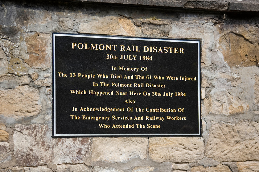 Commemorative plaque, Polmont station 
 A plaque attached to a wall at the western end of Polmont station to commemorate those who lost their lives as a result of the derailment of the 17.30 Edingburgh to Glasgow push-pull service on 30.07.84. The train was travelling through the station at about eight-five miles per hour with 47707 'Holyrood' providing the power at the rear. Just beyond the station the DBSO (converted Mk. II) hit a cow that had escaped onto the line from an adjacent field. The subsequent derailment caused thirteen fatalities and numerous injuries. The chief finding of the report was for object deflectors to be fitted to the leading vehicles of trains that had an axle load of less than sixteen tonnes. 
 Keywords: Commemorative plaque Polmont station