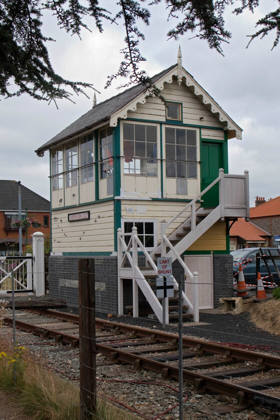 Sheringham East signal box (M&GN, 1906)jpg 
 The smart-looking Sheringham East signal box is seen standing approximately where it was first constructed by the M&GN in 1906. Following the truncation of the line from Cromer and the construction of the new station at Sheringham by BR in 1972 on the other side of Station Road, the box was set to be demolished. However, it was saved by the fledgling NNR society who dismantled the box removing the top and frame and placing a few hundred yards to the west on the old station platform. Later it became a small signalling museum with the original West box controlling all operations. However, in 2011 a successful planning application saw a new brick base constructed at its original position and the box moved again opening in 2012. However, the cones, missing fencing and red tape visible in this photograph indicate that things have not gone quite to plan, see......https://www.bbc.co.uk/news/uk-england-norfolk-22252923 
 Keywords: Sheringham East signal box