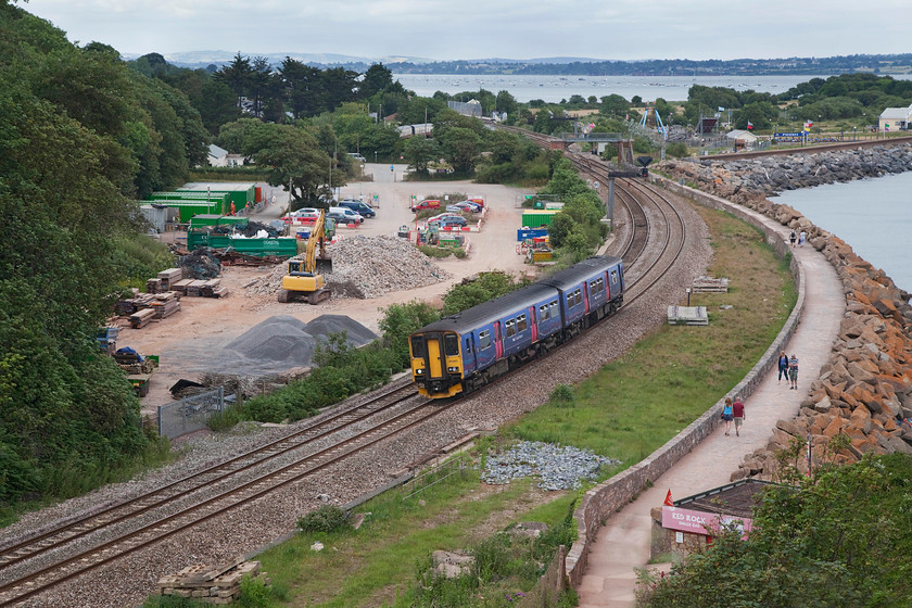 150265, GW 16.43 St. James Park-Paignton (2T23, 3E), Lanstone Rock 
 150265 has just left Dawlish Warren station with the 16.43 St. James' Park to Paignton working. The picture is taken from the famous Langstone Rock that offers commanding views of the railway in both directions and a spot that is favourite with many railway photographers past and present. 
 Keywords: 150265 2T23 Lanstone Rock