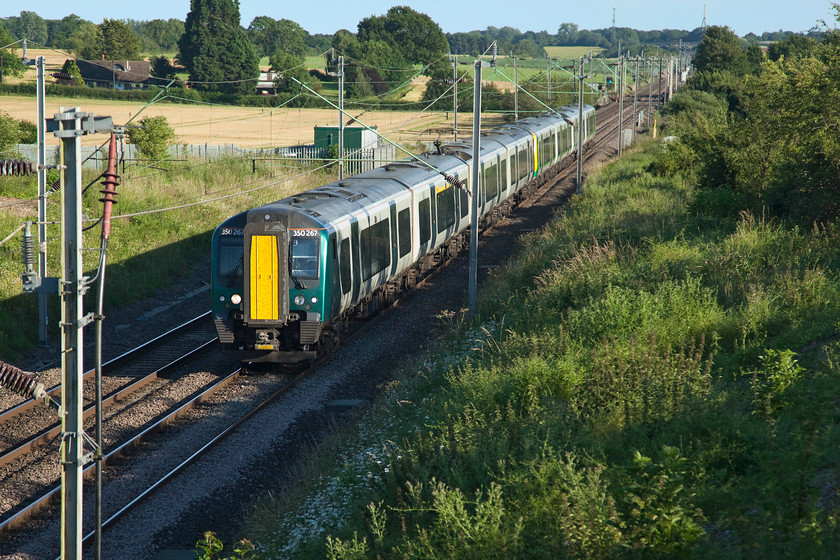 350267, LN 18.16 London Euston-Northampton (1N71, 1L), Milton Malsor SP738560 
 350267 in the 'new' London Northwestern livery leads one its stablemates in the old London Midland livery past Milton Malsor just on the approach to Northampton. It is forming the 18.16 Euston to Northampton 'fast' service that runs on the down fast non-stop as far as Ledburn Junction when it that moves to the slow stopping at Leighton Buzzard, Milton Keynes, Wolverton and arriving in Northampton (in theory) sixty-two minutes after it left. 
 Keywords: 350267 18.16 London Euston-Northampton 1N71 Milton Malsor SP738560