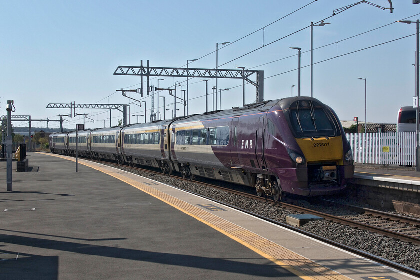 222011, EM 10.02 London St. Pancras-Sheffield (1F25, 16L), Wellingborough station 
 222011 sweeps northwards through Wellingborough with the 1F25 10.02 from St. Pancras to Sheffield. Wellingborough used to be an easy station to take photographs at with uncluttered views north and south. Since its modernisation and electrification views have become so much more cluttered as is the case here with modern infrastructure really spoiling things! 
 Keywords: 222011 10.02 London St. Pancras-Sheffield 1F25 Wellingborough station EMR East Midlands Railway Meridian