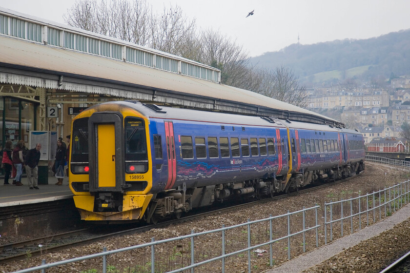 158955, GW 12.37 Cardiff Central-Portsmouth Harbour, Bath Spa station 
 One of FGW's Class 158 hybrid units pauses at Bath Spa working the 12.37 Cardiff to Portsmouth Harbour service. FGW have tacked on a driving coach from another set that has been split on a semi-permanent basis in order to add capacity. The whole new set created takes on one number, in this case 158955 that has also been refurbished in the last few years suggesting that they will be in service for some time to come. 
 Keywords: 158955 12.37 Cardiff Central-Portsmouth Harbour Bath Spa station FGW First Great Western