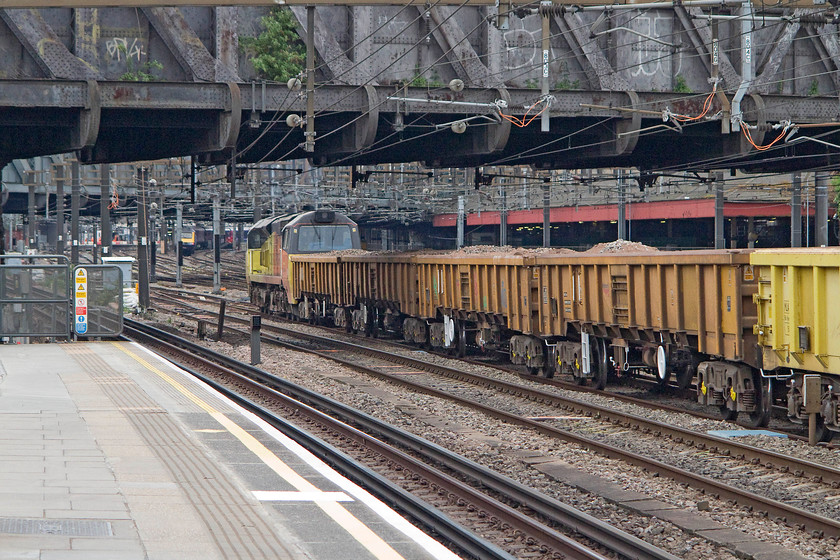 Class 70, ballast train for London Paddington, Royal Oak LU station 
 An unidentified class 70 makes it way at walking pace towards Paddington station. The ballast train went into one of the dark platforms on the north east side of the station ready for some engineering work that would take place over the bank holiday weekend. The picture is taken from Royal Oak LU station that I took the tube to. 
 Keywords: Class 70 Royal Oak LU station