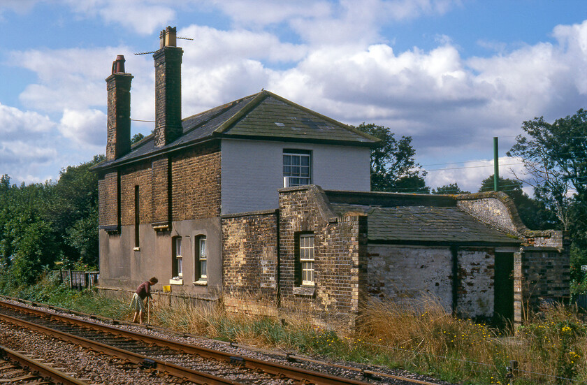 Former St. James Deeping station 
 Located on the so-called Lincolnshire Loop Line (Werrington Junction to Spalding) the former St. James Deeping station building is seen. The station opened in 1849 to serve residents of Deeping St. James with the Great Northern altering the name of the station as was often the case at this time. Bradshaw used the local spelling in one edition of his esteemed guide only to revert to the GNRs spelling in the next edition. Notice the resident of the former station house calmly trackside cloth in hand cleaning her windows! 
 Keywords: Former St. James Deeping station