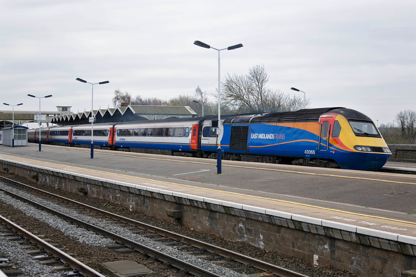 43066, EM 10.15 London St. Pancras-Nottingham (1D22), Kettering station 
 I had been on Kettering station for just under an hour and this was the first HST service that passed the station. The 10.15 St. Pancras to Nottingham sweeps through platform four with power car 43066 leading. As part of Eastern Region set 254006 this power car started its life late 1977 on the ECML for testing purposes. It was this set that formed the second official '125' service on the line working the 07.40 Kings Cross-Newcastle on 08.05.78. It later moved to the Midland Mainline in the mid to late 1980s. 
 Keywords: 43066 10.15 London St. Pancras-Nottingham 1D22 Kettering station East Midlands Trains HST