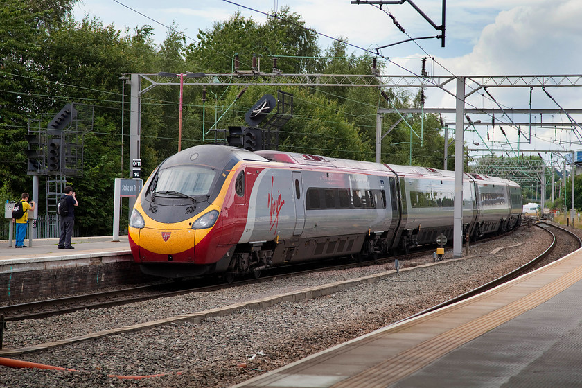 390137, VT 14.20 London Euston-Manchester Piccadilly (1H30), Stoke-on-Trent station 
 Being filmed by a couple of young enthusiasts, 390137 'Virgin Difference' departs from Stoke-on-Trent station. It is working the 1H30 14.20 Euston to Manchester Piccadilly. 
 Keywords: 390137 14.20 London Euston-Manchester Piccadilly 1H30 Stoke-on-Trent station