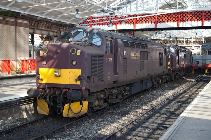 37706 & 37668, stabled, Crewe station 
 Two DRS class 37s stabled at Crewe station. Looking a little forlorn with faded and flat paintwork, 37706 is joined to a much smarter 37668. I really think that this EWS maroon livery is particularly poor and I am not quite sure what message is being sent by adopting this colour? 
 Keywords: 37706 37668 Crewe station