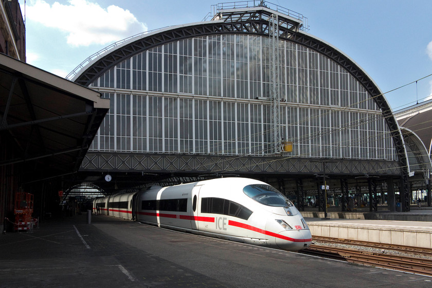 406 007, 16.32 Amsterdam Central-Frankfurt Hbf (ICE 129), Amsterdam station 
 DB ICE 129, the 16.32 Hi-speed working from Amsterdam to Frankfurt stands under Amsterdam Central station's impressive arch. This service is being worked by 406 007. These class 406s were built in the early 2000s specifically for the cross-border operations and are not quite as fast as their class 403 counterparts. This view emphasises the scale of Amsterdam Central station. The cast iron platform roof span is approximately 40 metres. Inside, following extensive refurbishment, the station is light and airy. 
 Keywords: 406 007 16.32 Amsterdam Central-Frankfurt Hbf ICE 129 Amsterdam station