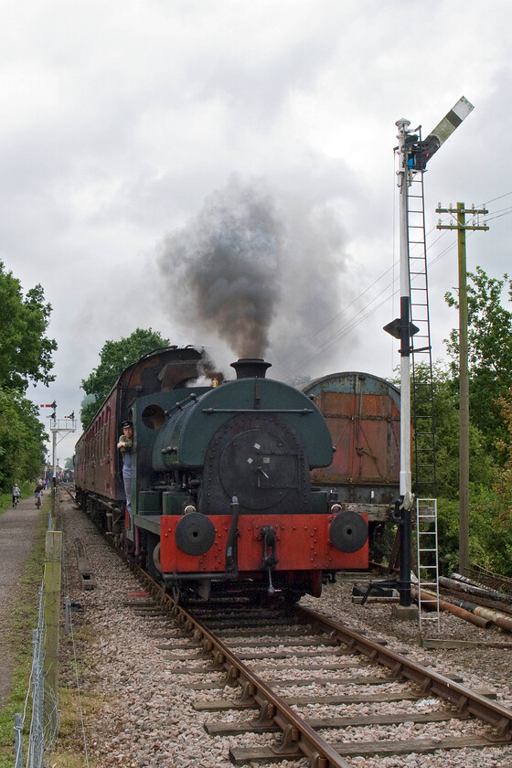 2104, 12.30 Pitsford return, Bridge 13 
 From this angle, it is clear to see the loading gauge of Peckett tank 2104 as it leads the 12.30 return service away from Brampton as it approaches bridge 13. The 1948 built 0-4-0 has been a regular performer on the preserved line for a number of years. recently it was awarded an extension to its boiler certificate but this will run out in two years time when it will need a re-build. 
 Keywords: 2104 12.30 Pitsford return Bridge 13 Northampton & Lamport Railway NLR